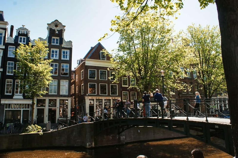 Amsterdam: Iconic Canals & Historic Sights Walking Tour - Quiet moments at the Begijnhof