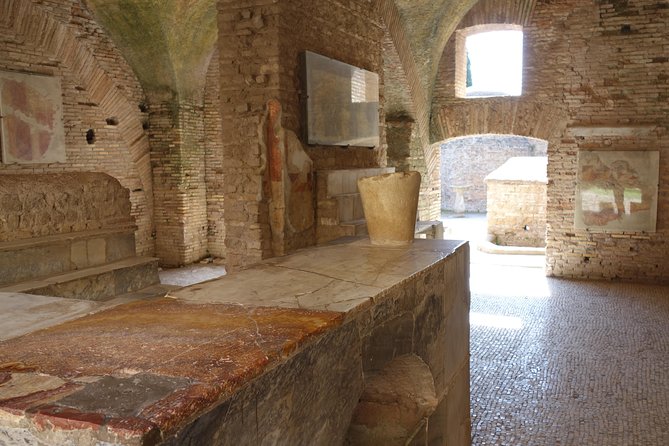 Ancient Ostia Antica Semi-Private Day Trip from Rome by Train with Guide - The amphitheater and Forum of the Corporations