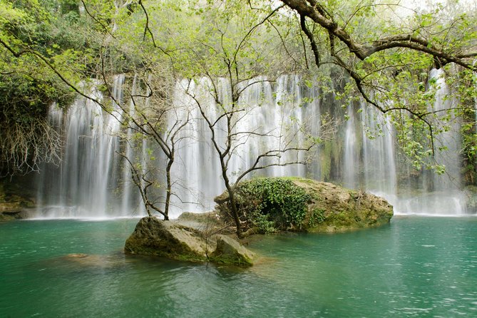 Full-Day Tour of Kursunlu Waterfalls, Aspendos, and Ancient Ruins of Side From Alanya - Kursunlu Waterfalls among pines and old machinery